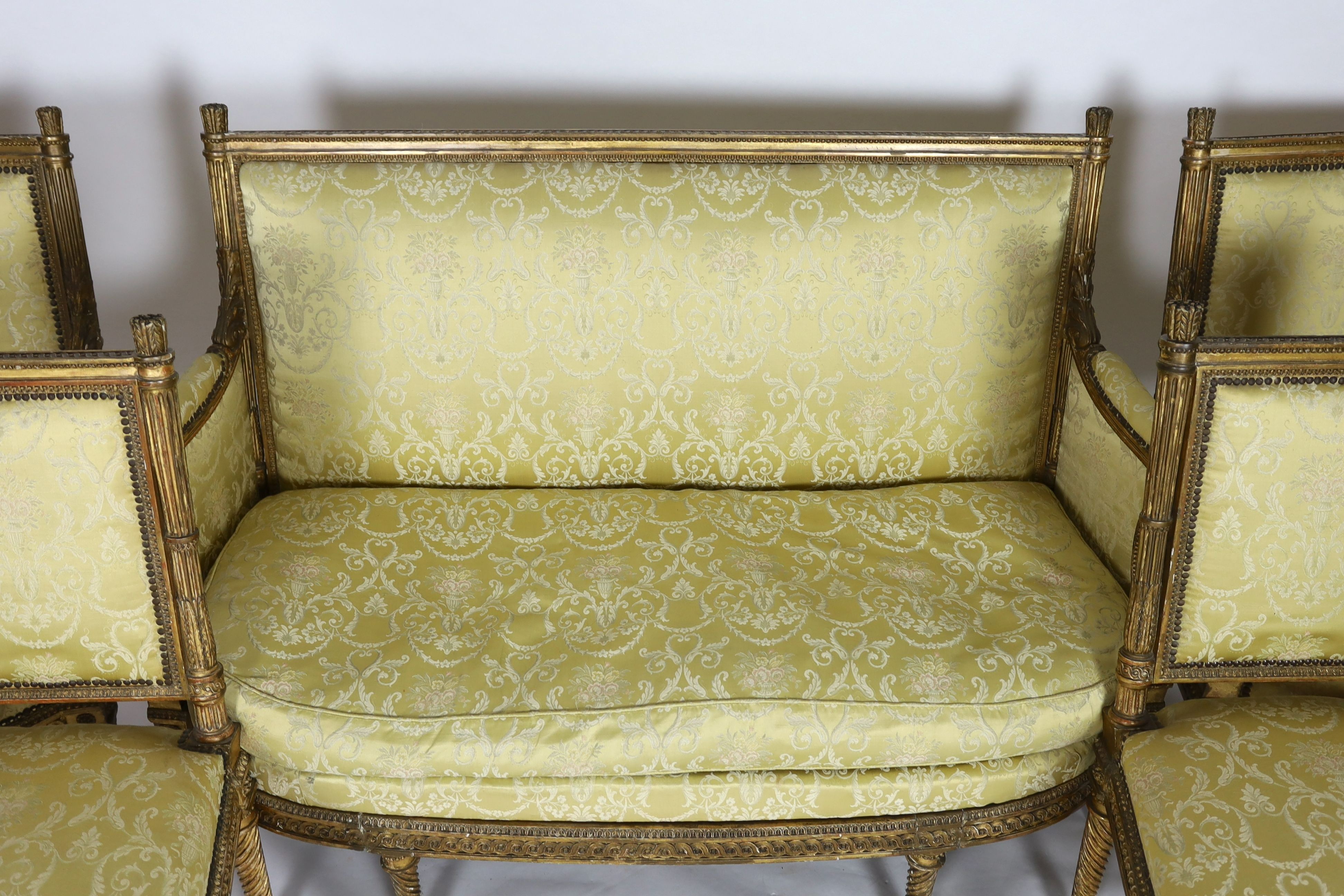 A Louis XVI carved giltwood five piece salon suite, settee W.148cm D.69cm H.100cm